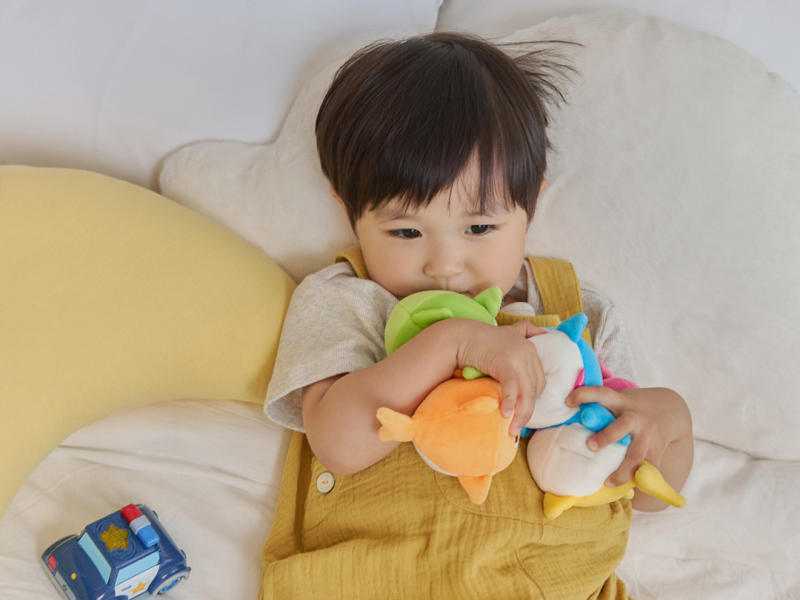 Child hugging the Baby Shark Squishy Charm Plush