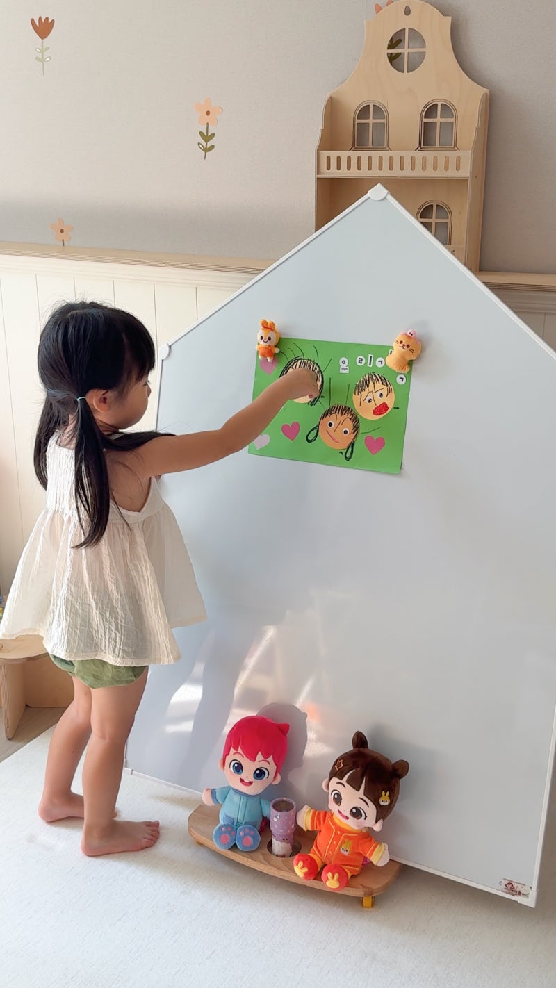 Child sticking a Bebefinn Magnetic Cuddle Plush onto a magnetic board
